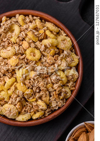 Flakes, chocolate balls and dried fruit for a hearty breakfast 127687031
