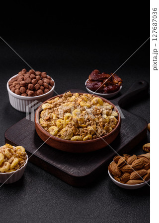 Flakes, chocolate balls and dried fruit for a hearty breakfast Flakes, chocolate balls and dried fruit for a hearty breakfast 127687036