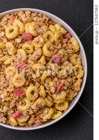 Flakes, chocolate balls and dried fruit for a hearty breakfast Flakes, chocolate balls and dried fruit for a hearty breakfast 127687063