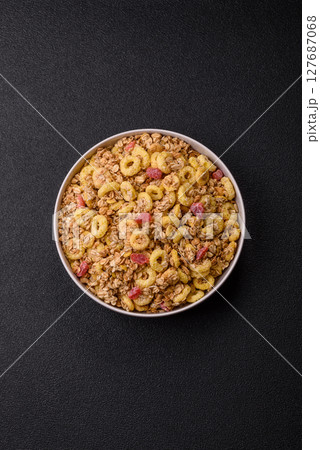 Flakes, chocolate balls and dried fruit for a hearty breakfast 127687068