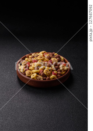 Flakes, chocolate balls and dried fruit for a hearty breakfast Flakes, chocolate balls and dried fruit for a hearty breakfast 127687092