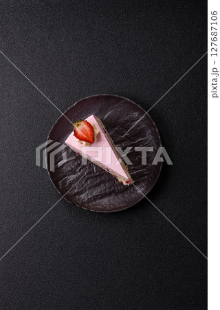 A slice of pink colored puff cake for a birthday celebration 127687106
