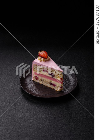 A slice of pink colored puff cake for a birthday celebration A slice of pink colored puff cake for a birthday celebration 127687107