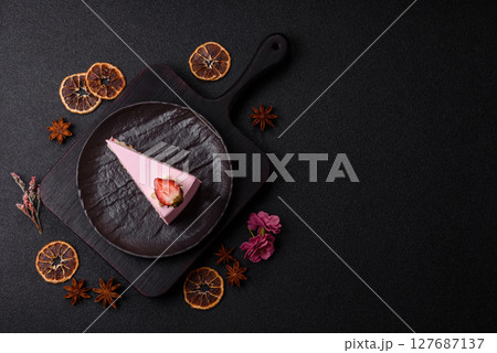 A slice of pink colored puff cake for a birthday celebration 127687137