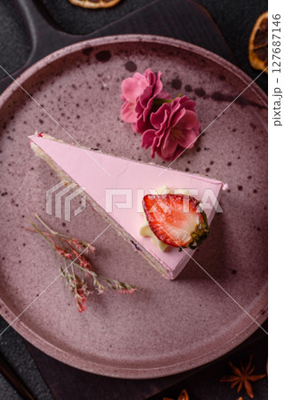 A slice of pink colored puff cake for a birthday celebration 127687146