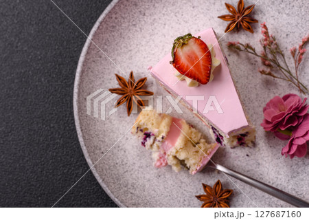 A slice of pink colored puff cake for a birthday celebration A slice of pink colored puff cake for a birthday celebration 127687160