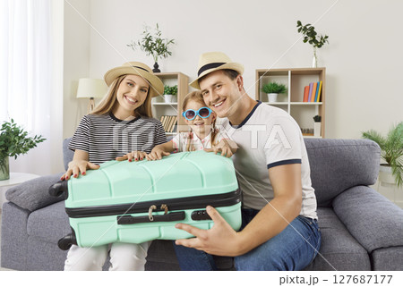 Family tourist summer vacation happy packing suitcase together at home laughing planning, preparing 127687177
