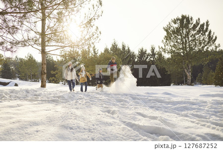 Happy smiling family with kids walking in winter park having fun with snow together in forest. 127687252