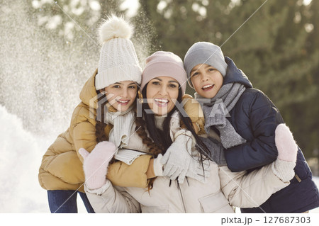 Happy mother with kids standing outdoors enjoying beautiful nature in winter forest. Happy mother with kids standing outdoors enjoying beautiful nature in winter forest. 127687303