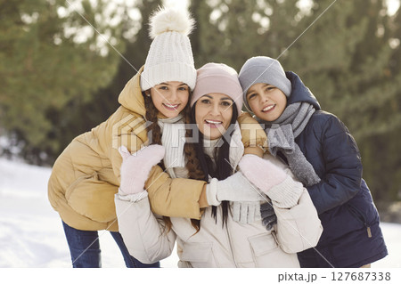Happy Mother With Children On A Winter Forest Walk 127687338