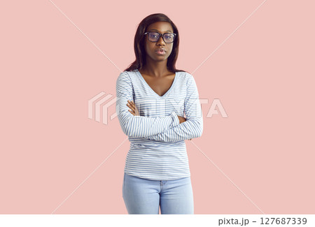 Portrait of serious African American college or high school student girl with folded arms 127687339