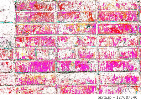 Peeling paint on a brick wall. Old brick wall with cracked peeling paint. 127687340