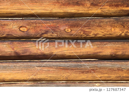 log wall. light wooden wall. environmentally friendly house. wooden blockhouse. wood fibers. logs.  127687347