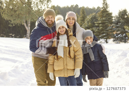 Happy smiling family, winter snowy outdoor portrait spending Christmas holiday wearing warm outfit Happy smiling family, winter snowy outdoor portrait spending Christmas holiday wearing warm outfit 127687373
