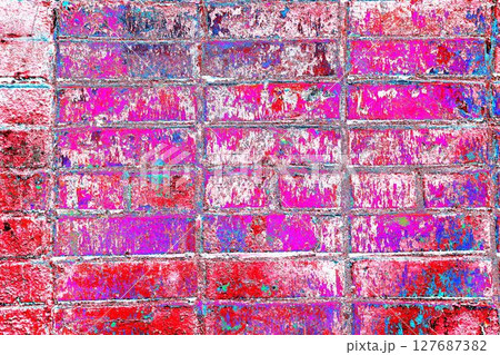 Peeling paint on a brick wall. Old brick wall with cracked peeling paint. 127687382