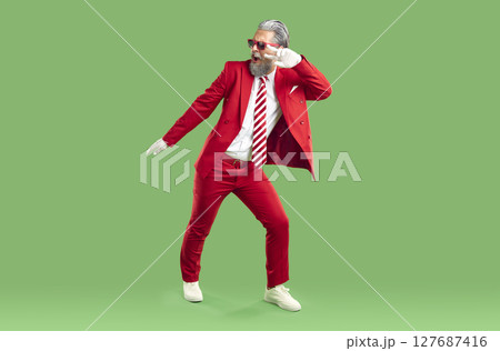 Positive extravagant gray-haired Santa Claus dressed in classic stylish red suit. Positive extravagant gray-haired Santa Claus dressed in classic stylish red suit. 127687416