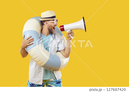 Funny man with beach ring and megaphone makes announcement about summer holiday sale Funny man with beach ring and megaphone makes announcement about summer holiday sale 127687420