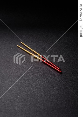 Stick or chopstick Japanese or Chinese for eating sushi, rolls Stick or chopstick Japanese or Chinese for eating sushi, rolls 127687818