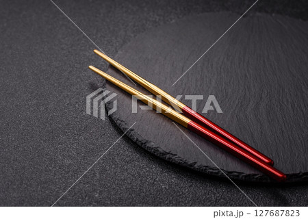 An empty plate with chopsticks for Japanese or Chinese food 127687823
