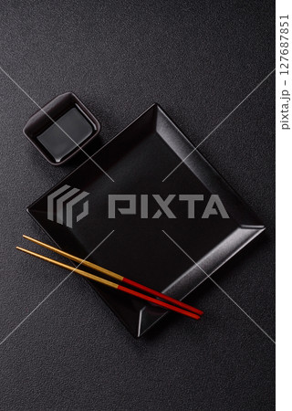 An empty plate with chopsticks for Japanese or Chinese food An empty plate with chopsticks for Japanese or Chinese food 127687851