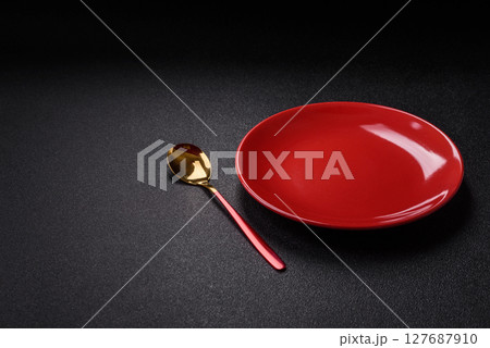 Empty plate with spoon, cutlery for dinner table Empty plate with spoon, cutlery for dinner table 127687910