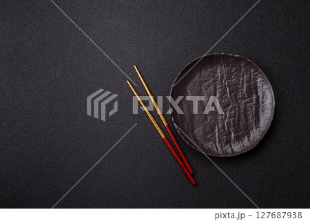 An empty plate with chopsticks for Japanese or Chinese food 127687938