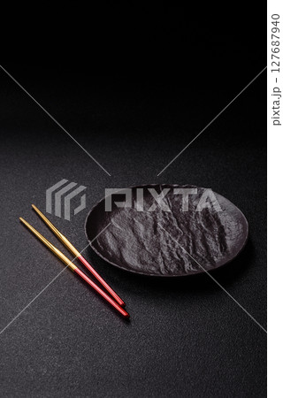 An empty plate with chopsticks for Japanese or Chinese food An empty plate with chopsticks for Japanese or Chinese food 127687940