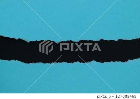 Blue ripped paper placed on black background paper with copy space 127688469