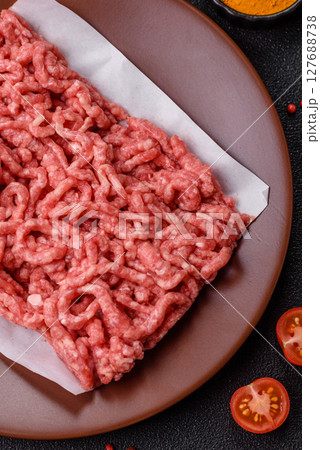Stuffing or ground raw beef or pork with salt and spices 127688738