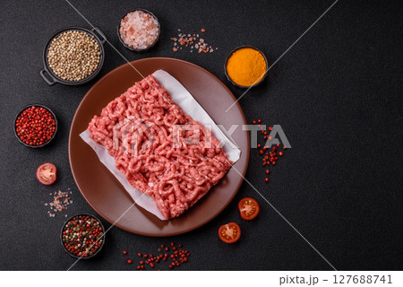 Stuffing or ground raw beef or pork with salt and spices 127688741