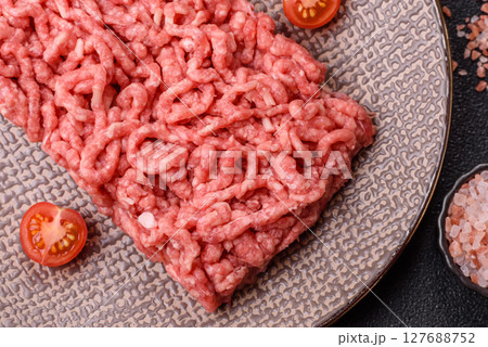 Stuffing or ground raw beef or pork with salt and spices 127688752