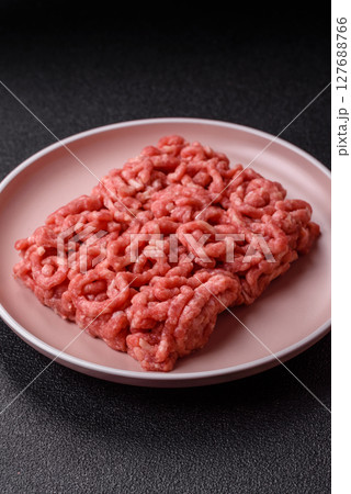 Stuffing or ground raw beef or pork with salt and spices 127688766