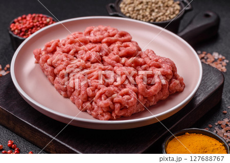 Stuffing or ground raw beef or pork with salt and spices 127688767