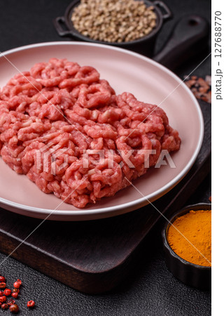 Stuffing or ground raw beef or pork with salt and spices 127688770
