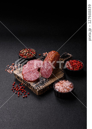 Sliced salami sausage, smoked meat, delicious deli snacks 127688839