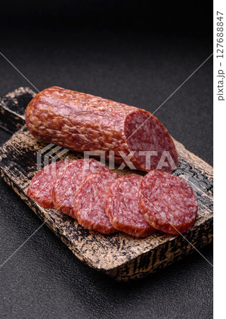 Sliced salami sausage, smoked meat, delicious deli snacks 127688847