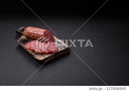 Sliced salami sausage, smoked meat, delicious deli snacks Sliced salami sausage, smoked meat, delicious deli snacks 127688848