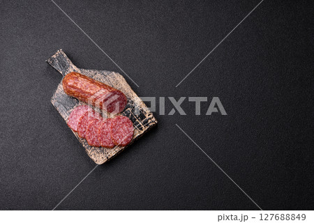 Sliced salami sausage, smoked meat, delicious deli snacks 127688849