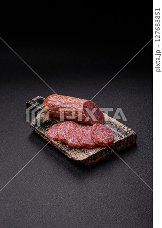 Sliced salami sausage, smoked meat, delicious deli snacks Sliced salami sausage, smoked meat, delicious deli snacks 127688851