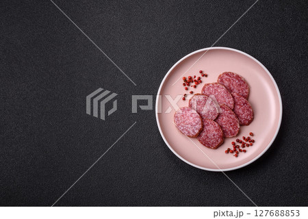 Sliced salami sausage, smoked meat, delicious deli snacks Sliced salami sausage, smoked meat, delicious deli snacks 127688853