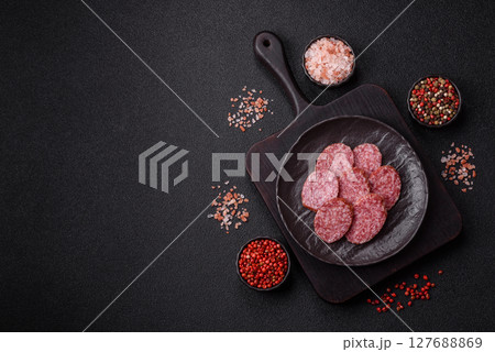 Sliced salami sausage, smoked meat, delicious deli snacks Sliced salami sausage, smoked meat, delicious deli snacks 127688869