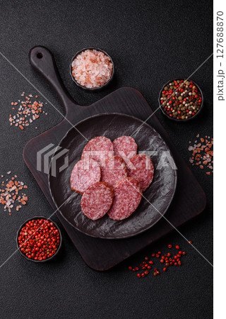 Sliced salami sausage, smoked meat, delicious deli snacks Sliced salami sausage, smoked meat, delicious deli snacks 127688870