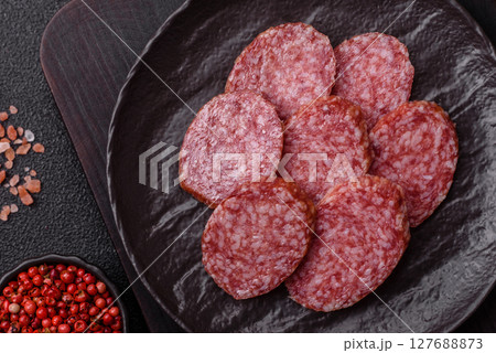 Sliced salami sausage, smoked meat, delicious deli snacks 127688873