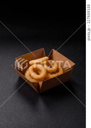 Onion rings or squid rings fries crispy, savory with sauce 127689188