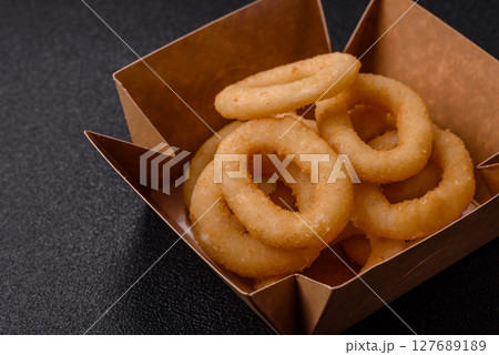 Onion rings or squid rings fries crispy, savory with sauce 127689189