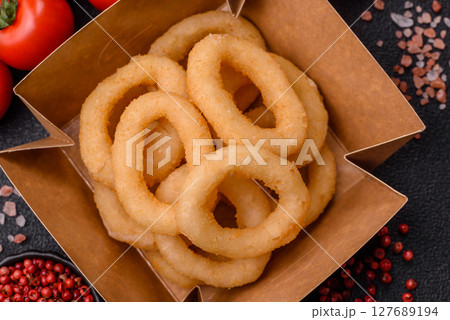 Onion rings or squid rings fries crispy, savory with sauce 127689194