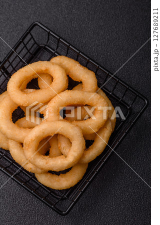 Onion rings or squid rings fries crispy, savory with sauce Onion rings or squid rings fries crispy, savory with sauce 127689211