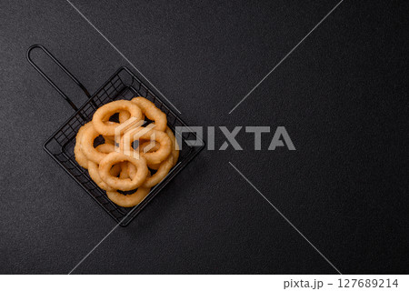 Onion rings or squid rings fries crispy, savory with sauce Onion rings or squid rings fries crispy, savory with sauce 127689214