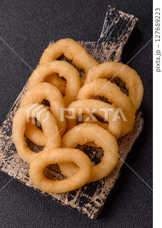 Onion rings or squid rings fries crispy, savory with sauce Onion rings or squid rings fries crispy, savory with sauce 127689223