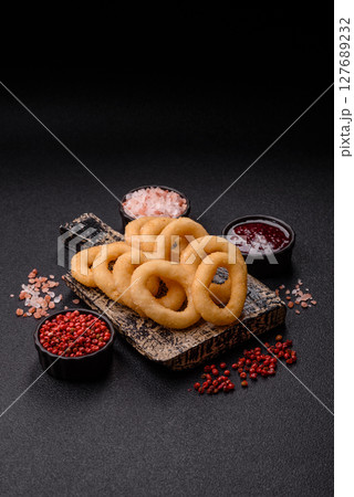 Onion rings or squid rings fries crispy, savory with sauce Onion rings or squid rings fries crispy, savory with sauce 127689232